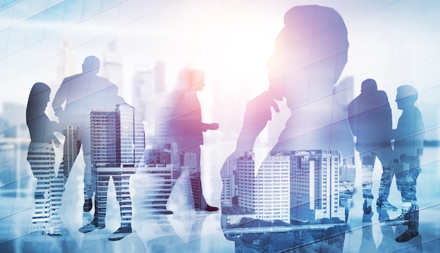 Silhouette image of business people group on city background