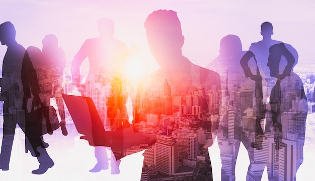 Silhouette image of business people group on city background