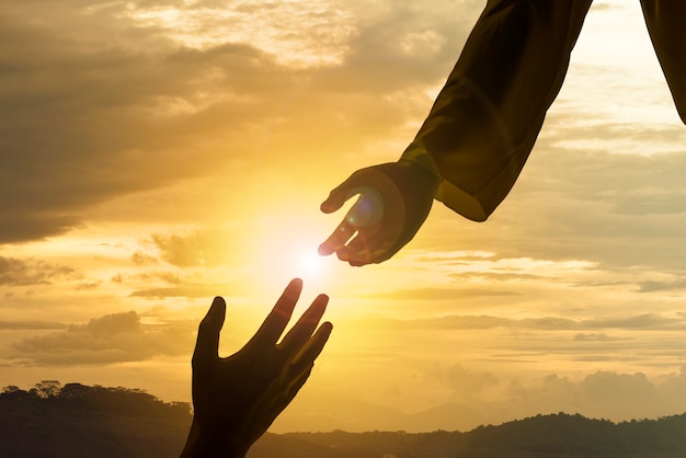 Silhouette of Jesus giving helping hand