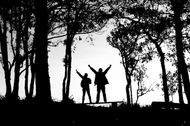 silhouette of love couple in trees border, back and white tone