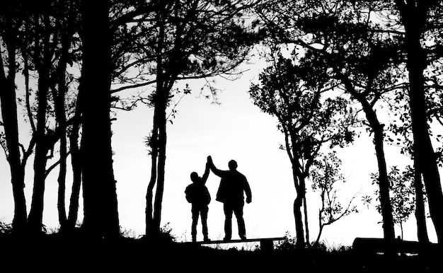 silhouette of love couple in trees border, back and white tone