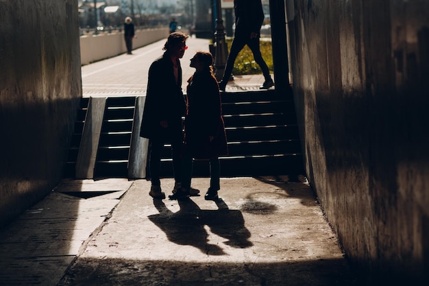 Silhouette of loving young couple standing face to face at Valentines day dating