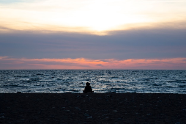 Silhouette of a man on the background of the sunset