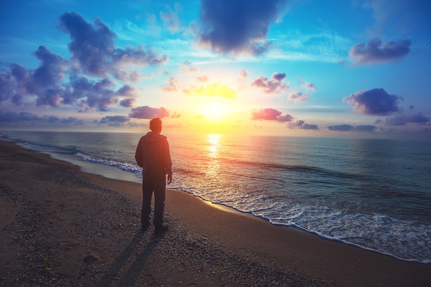 Silhouette of man on the beach at sunris