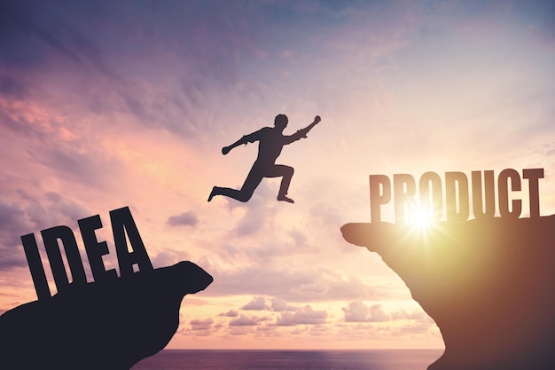 Silhouette of a man jumping from cliff to cliff business and success concept