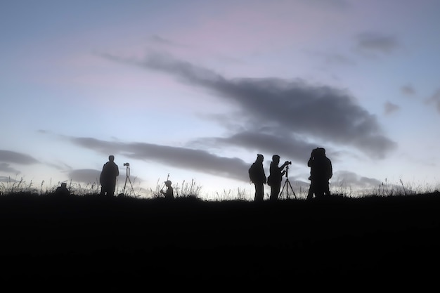 Silhouette of the man success on the peak of mountain 