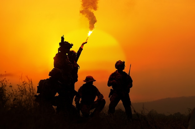 The silhouette of a military soldier with the sun as a Marine Corps for military operations