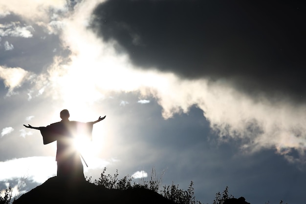 Silhouette monk on the mountain prayer moses faith god