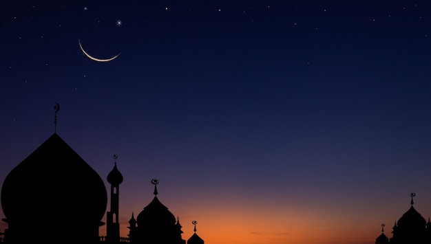 Silhouette mosques dome on dusk sky in the evening and crescent moon for symbol Islamic religion