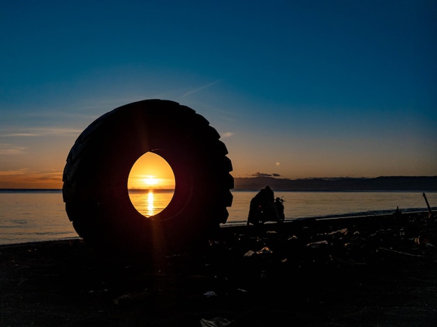 Silhouette of objects on the beach with sunrise