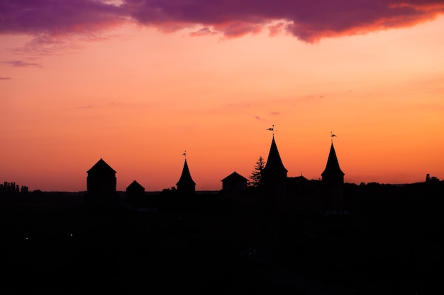 Silhouette of an old medieval castle during sunset