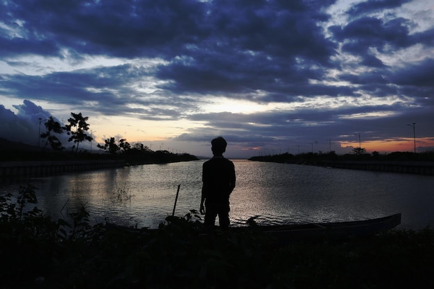 silhouette of a person on the lake