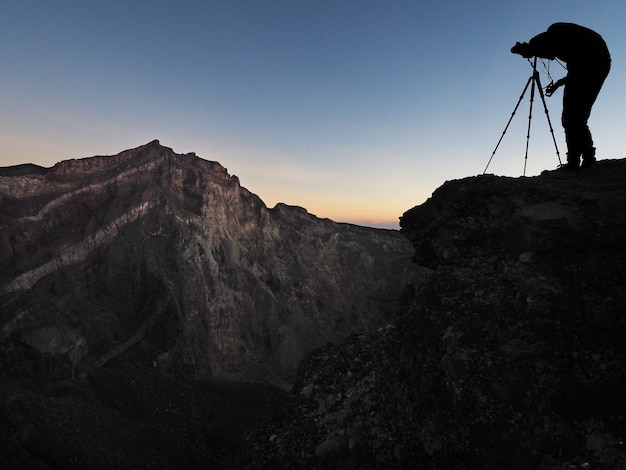 Silhouette of photographer taking landscape photo at Agung Volcano Mountain