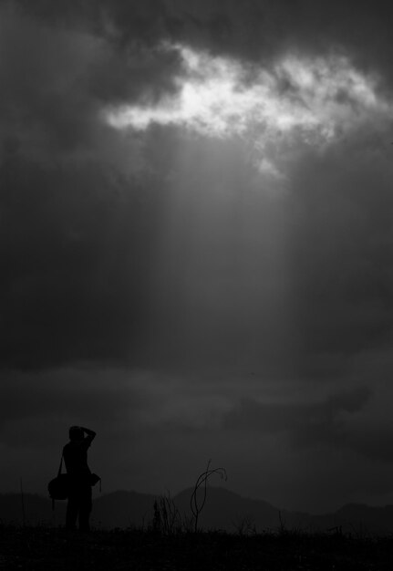 silhouette of photographer taking picture of landscape during sunrise sunset