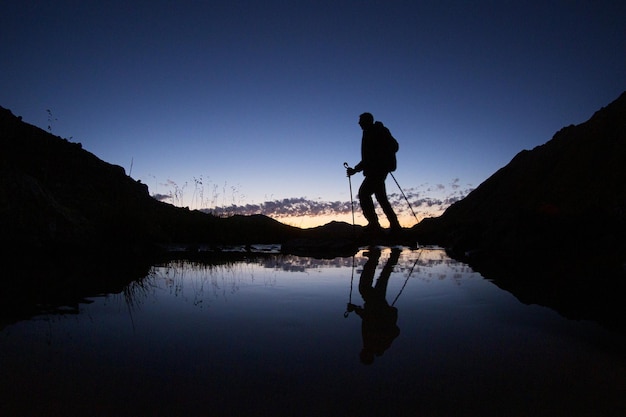 Silhouette reflection of mountaineer hiking in the Lake Wenatchee state park in Chelan WA USA