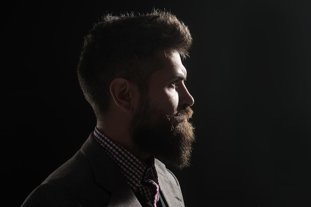 Silhouette of serious bearded man in vintage style hipster profile portrait pensive man in retro