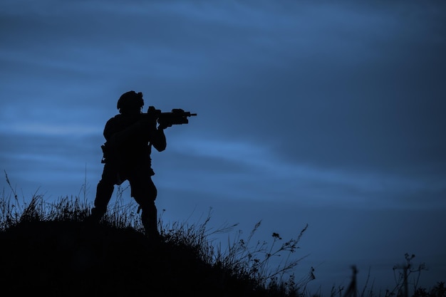 Silhouette of soldier with riflexAxA