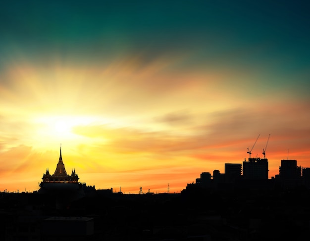 Silhouette of the temple and the city of evening time with beautiful sky light