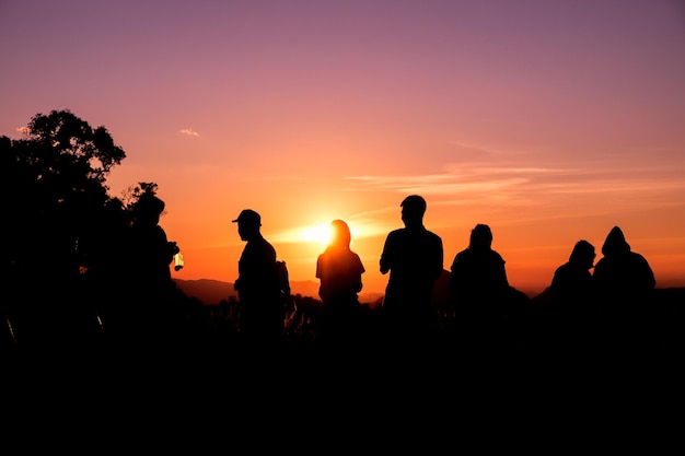 Silhouette tourists stand looking view