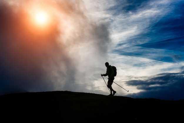 Silhouette of a trekking man on a mountain