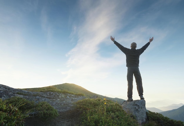 Silhouette of a winner on mountain top Sport and active life conceptxA