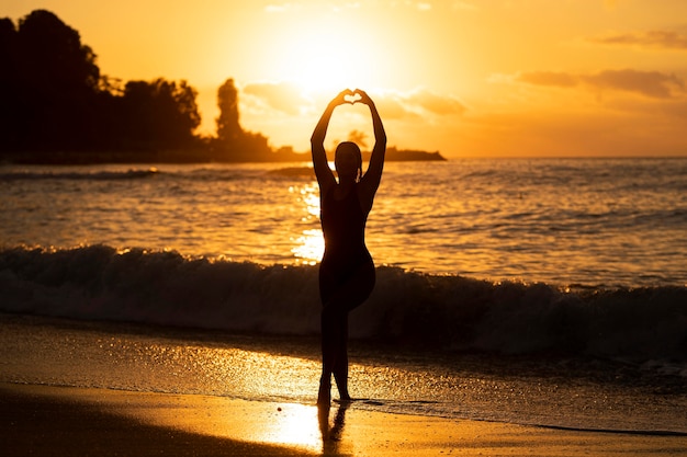 Silhouette of woman posing by the beach