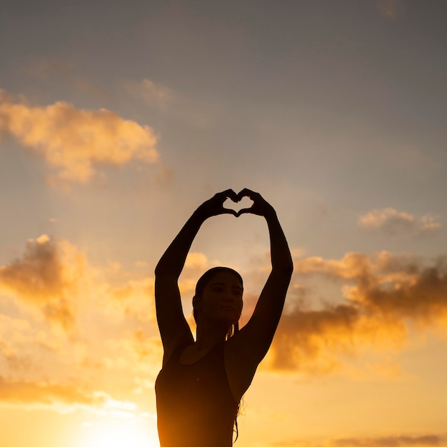 Silhouette of woman posing by the beach