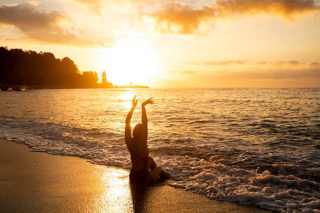 Silhouette of woman posing by the beach