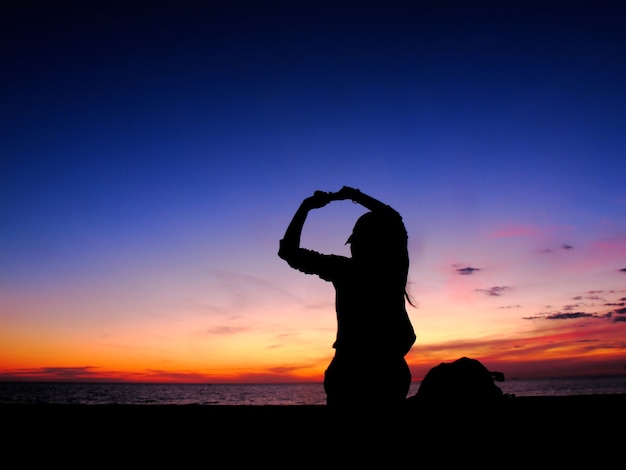 silhouette woman sit at sea