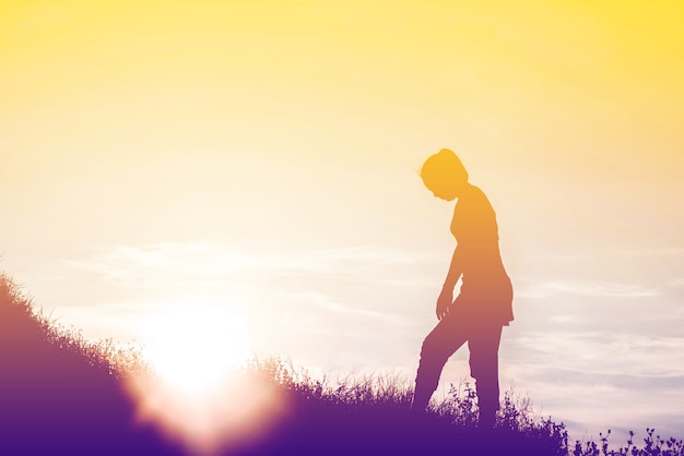 Silhouette of woman So happy at sunset