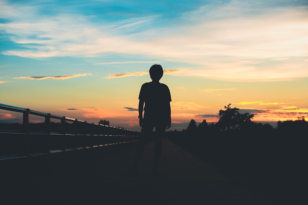 Silhouette woman with sadness at sunset alone.