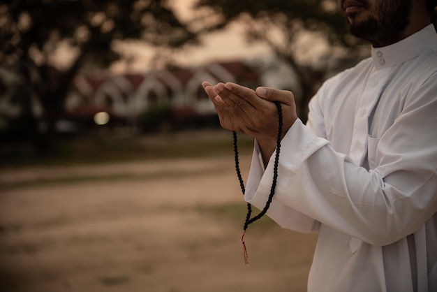 Silhouette Young asian muslim man praying on sunsetRamadan festival concept