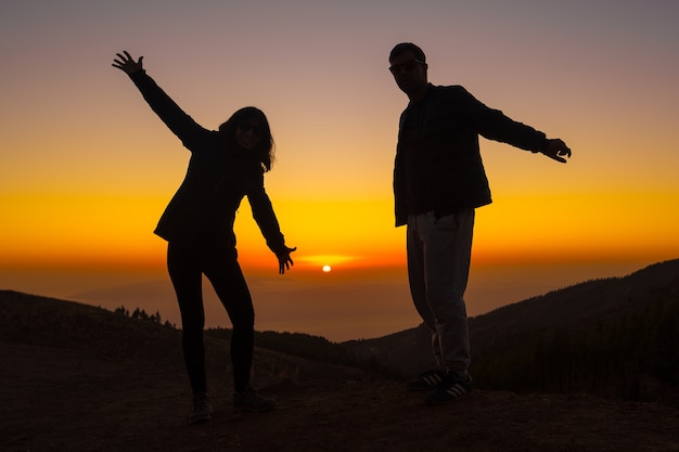 Silhouette of young people at sunset on top of Mount Teide on the Island of Tenerife