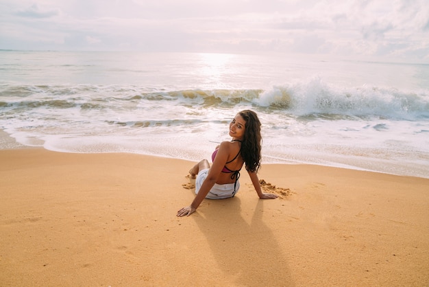 Silhouette of young woman on the beach