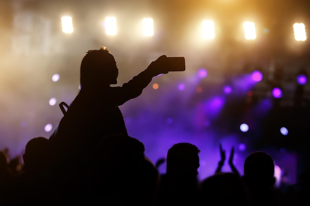 Silhouette of Young Woman Taking Selfie Picture Using her Smartphone