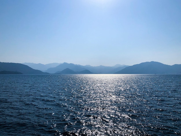 Silhouettes of hills and mountains on the Mediterranean. Summer landscape with sea and mountain range. Mountain view on the horizon in the sea. Blue mountains and blue sea. Landscapes Of Marmaris