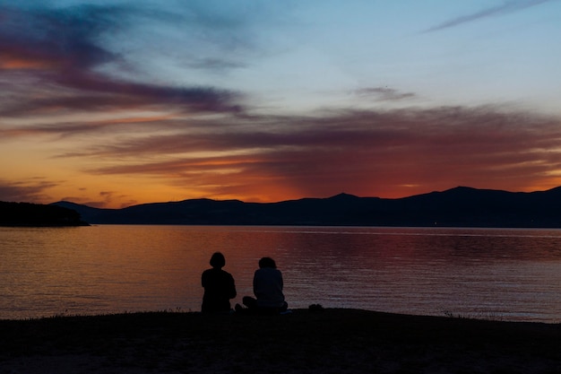 Silhouettes on people on the beach at sunset