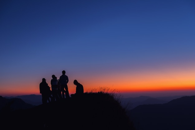 Silhouettes of people on mountains 