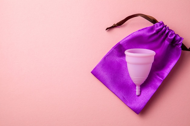 Silicone menstrual cup. Women's health and alternative hygiene. Pink.