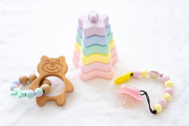 Photo silicone pyramid and teethers for teeth of beautiful colors on a white background