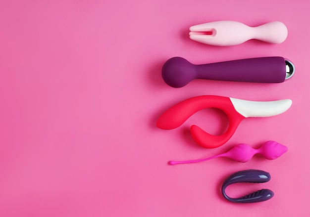 Silicone sex toys on a pink background. Erotic toy for fun. Sex gadget and masturbation device.