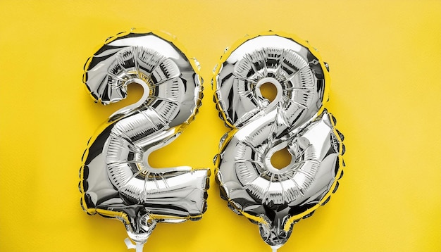 Silver balloon number 28 over isolated yellow backdrop Birthday celebration Anniversary card