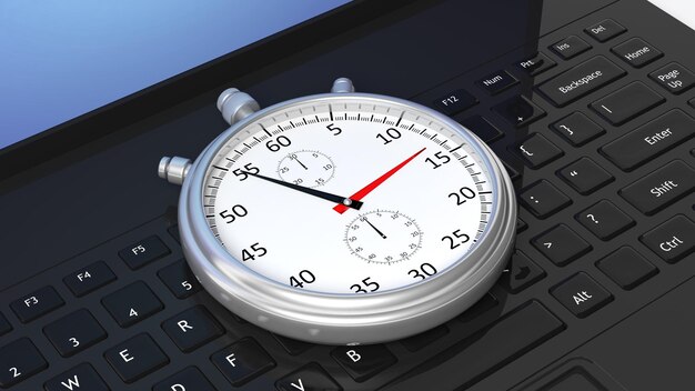 Silver chronometer on black laptop keyboard