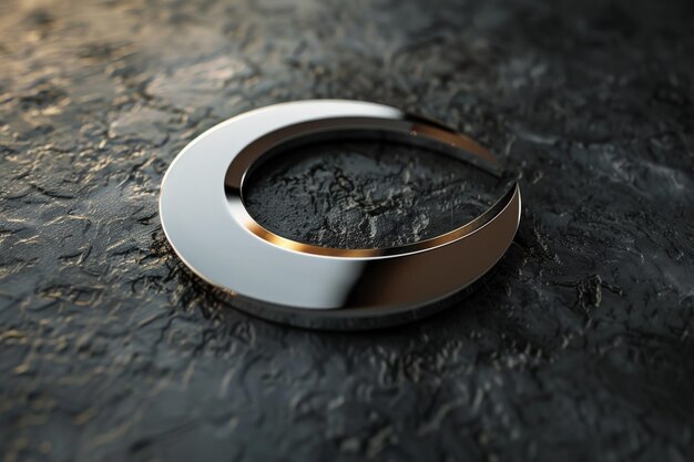 Photo a silver circle with a curved edge sits on a black surface