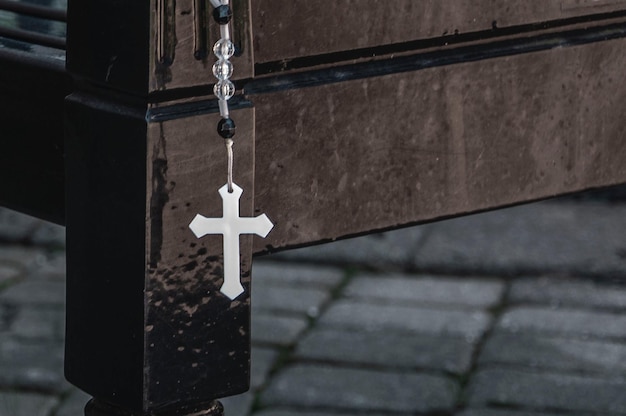 A silver cross hangs from a chain