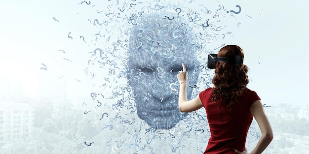 Silver digital head and a young woman wearing a red dress, in virtual reality headset. Mixed media