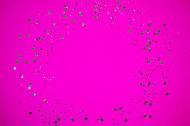 Silver glitter on neon pink background