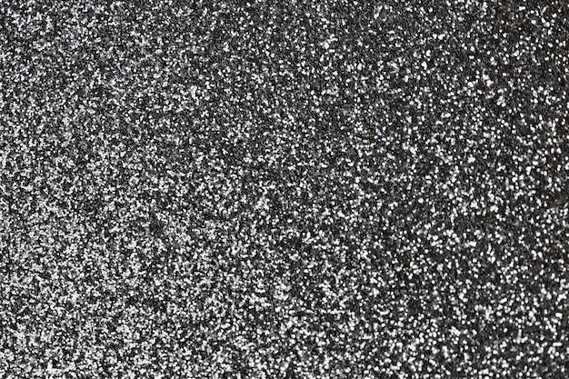 Silver glitter texture. New Year or christmas background for greeting card. Valentines Day celebration. Shiny sparkle design for festive decoration: wedding, holiday or anniversary party.