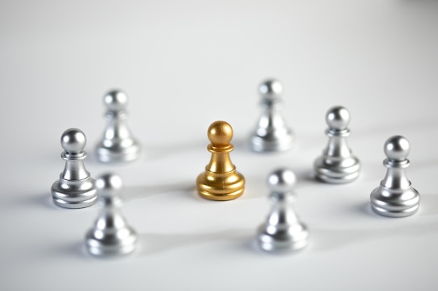 Silver and gold chess on white background.