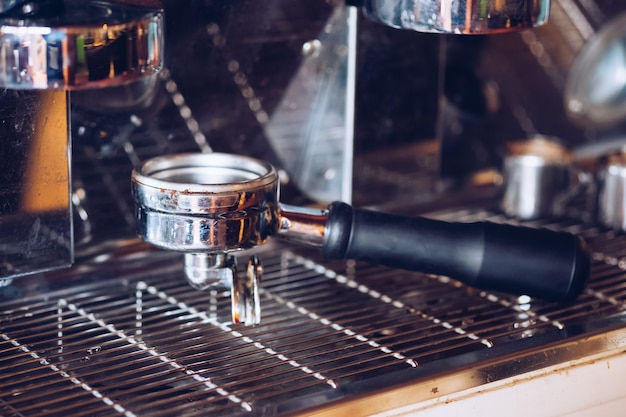 Silver grinder put on coffee maker, filter retro style